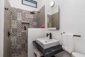 a white bathroom with a sink and a mirror at 2 legit 2 quit in San Pancho in San Francisco +34 photos