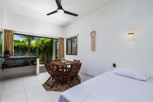 a bedroom with a bed and a table and a tub at 4 by 4 means 8 is great in San Pancho in San Francisco