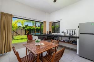 a kitchen and dining room with a table and a refrigerator at 2 and 2 makes a great Getaway in San Francisco