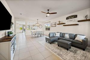 a large living room with a couch and a tv at The Fiddyment Roost in Roseville