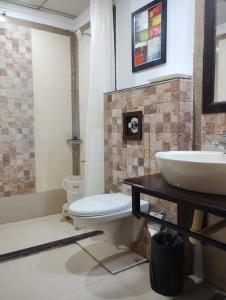 a bathroom with a sink and a toilet at Hotel Amba International in Jodhpur +10 photos