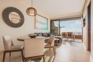 a dining room with a table and a couch at Casa de Luz Beachfront Oasis w Ocean Views Pool in San Francisco