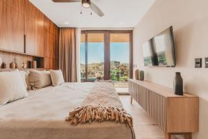 a bedroom with a large bed with a large window at Your Sayulita Getaway in Sayulita +40 photos