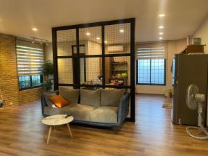 salon z kanapą i stołem w obiekcie Không gian xanh an yên bên Hồ Tây w mieście Hanoi