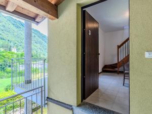 a room with a door leading to a balcony at Apartment Borgo Castello-4 by Interhome in Argegno