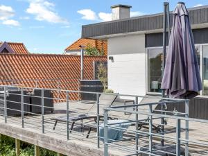 a purple umbrella and two chairs on a deck at Holiday Home Delan - 75m from the sea by Interhome in Hejlsminde +28 photos