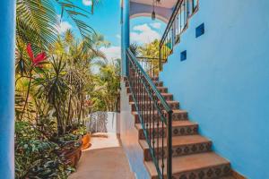 a staircase leading up to a house with palm trees at Rooftop Terrace Heated Pool Sayulita 2BR in Sayulita