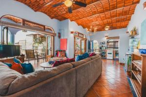 a large living room with a couch and a table at Rooftop Terrace Heated Pool Sayulita 2BR in Sayulita
