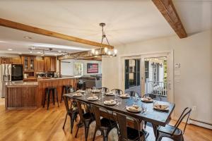 a dining room and kitchen with a table and chairs at Gilford Getaway - Pool & Hot Tub - Lakes Region in Gilford