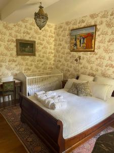 a bedroom with a large bed with towels on it at Château de Miguillaume 