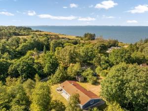 an aerial view of a house with the ocean in the background at Holiday Home Elizabeth - 150m to the fjord by Interhome in Furland