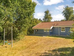 a house with a yard and a basketball hoop at Holiday Home Elizabeth - 150m to the fjord by Interhome in Furland +18 photos