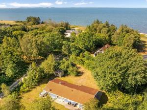 an aerial view of a house with trees and the ocean at Holiday Home Elizabeth - 150m to the fjord by Interhome in Furland