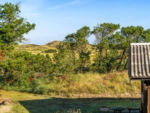 a view of a hill with trees and a bench at Holiday Home Anneka - 750m from the sea by Interhome in Rødhus +3 photos