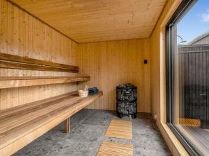 an empty sauna with a bench and a stove at Holiday Home Artur - 800m from the sea by Interhome in Fjellerup