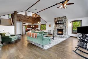 a living room with a couch and a fireplace at 5 Bedroom Suites Hot Tub Jacuzzi Tub & Game Room in Berkeley Springs