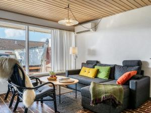a living room with a couch and a table at Apartment Enwald - 700m from the sea by Interhome in Rødhus