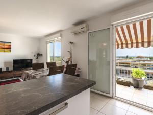 a kitchen and living room with a view at Apartment Albarella by Interhome in LʼArena