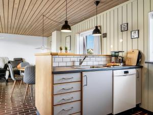 a kitchen with a sink and a counter at Apartment Enwald - 700m from the sea by Interhome in Rødhus