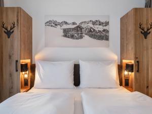 a bedroom with a bed with two white pillows at Studio Studio Taxacher by Interhome in Krinberg