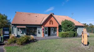 a small house with an orange roof at Campanile NATURE - Bordeaux Sud Gradignan Talence in Gradignan