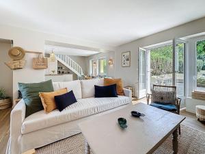 ein Wohnzimmer mit einer weißen Couch und einem Tisch in der Unterkunft Holiday Home La Nero by Interhome in Pornic