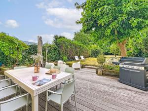 einen Tisch und Stühle auf einer Terrasse mit Grill in der Unterkunft Holiday Home La Nero by Interhome in Pornic