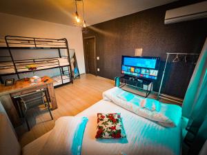 a bedroom with two bunk beds and a television at AmurResidence Sauna 5 APARTMENTS free Parking in Iaşi