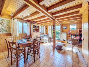 a dining room with a table and chairs at Holiday Home Les Chalets de La Combe by Interhome in Mémontel