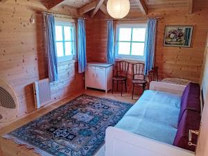 a bedroom in a log cabin with a bed and a table at Holiday Home Haus direkt am Ossiacher See by Interhome in Annenheim