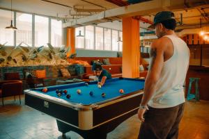 two men standing around a pool table at Viajero Casco Viejo Hostel in Panama City