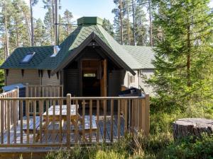 a tiny house with a porch and a green roof at Chalet Hazel Bothy by Interhome in Coldstone