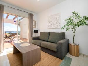 a living room with a couch and a table at Apartment Imperial Park-23 by Interhome in Casas de Torrat