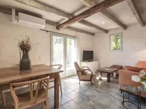 a living room with a table and a couch at Holiday Home Casa Murato by Interhome in San-Giuliano