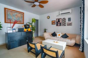 a living room with a couch and a table at BVB Holiday Villa - 24h Airport Included in Shanghai