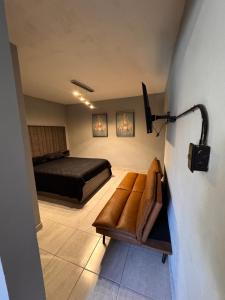 a bedroom with a bed and a chair in a room at Estancias Nava #1 in San Antonio