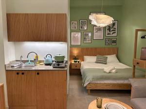 a kitchen with a bed and a sink in a room at Praia Suites - Batroun in Batroûn