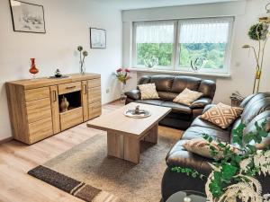 a living room with a couch and a table at Apartment Marie by Interhome in Schieder-Schwalenberg