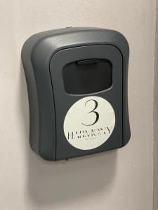 a black object with the number three on it at Harmony Apartments Airport in Iaşi