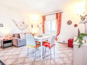a living room with a table and chairs and a couch at Apartment Vista Paradiso by Interhome in Cascabraga