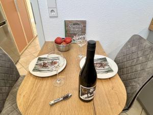 a bottle of wine sitting on a table with glasses at Apartment Feingeist by Interhome in Löffingen