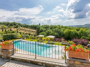 an outdoor swimming pool with flowers on a balcony at Holiday Home Casa Padronale by Interhome in Corti