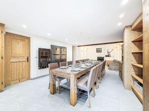 a dining room with a wooden table and chairs at Chalet Chalet La Bergerie by Interhome in Les Brévières