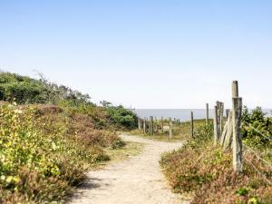 a dirt path leading up a hill to the ocean at Holiday Home Frösakull by Interhome in Frösakull
