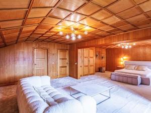 a living room with a couch and a bed at Chalet Champ de Brent by Interhome in Huémoz