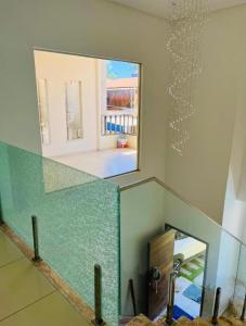 a mirror on the wall of a room with a staircase at Casa Lalivi Trancoso in Porto Seguro