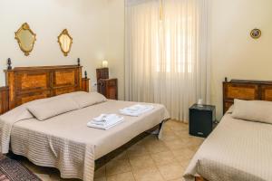 Postel nebo postele na pokoji v ubytování Camere del Camerlengo + 1 fotografie