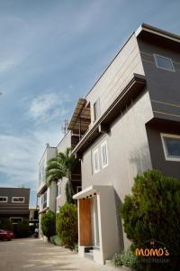 a large building with a driveway in front of it at Momo's Hotel in Kumasi