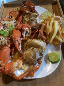 a plate of food with shrimp and french fries at Happybeach Sea view Cabin in Tangalle