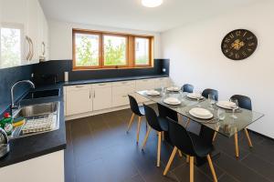 a kitchen with a dining room table and chairs at Koblenz Exclusive Residence in Koblenz